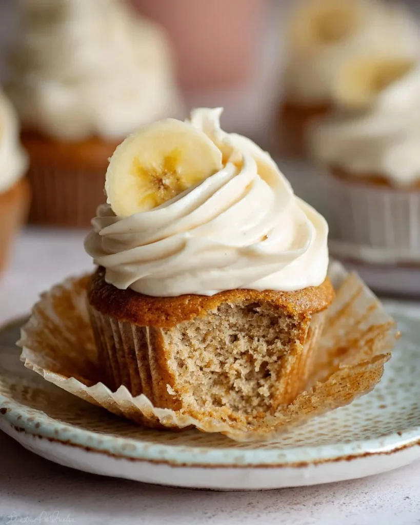 Delicious banana cupcakes with cinnamon cream cheese frosting on a platter