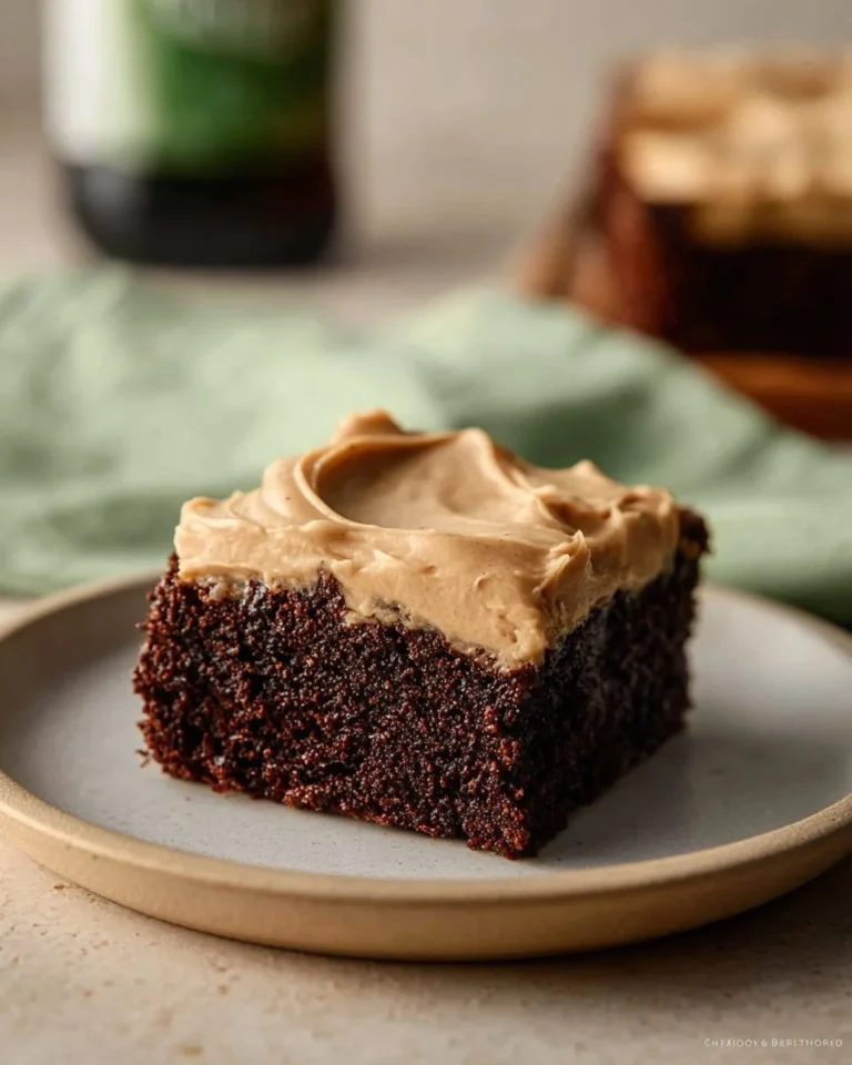 Delicious Guinness brownies with smooth Guinness frosting on a baking tray.