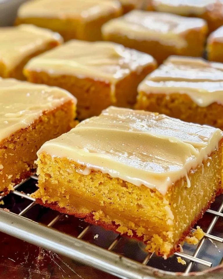 Delicious pumpkin sheet cake topped with brown butter icing on a rustic table.